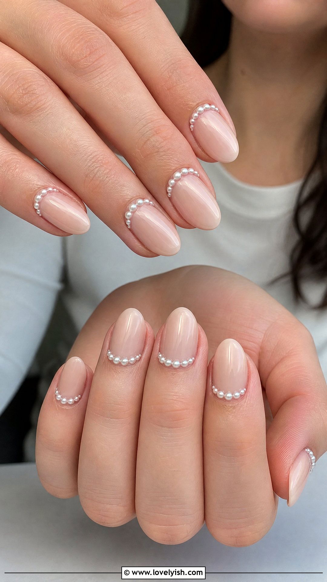 Nude nails with a halo of tiny pearls tracing the cuticle line