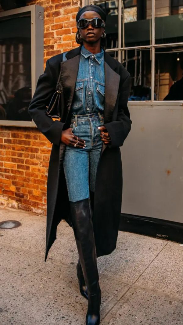 Woman in a black coat with a denim outfit