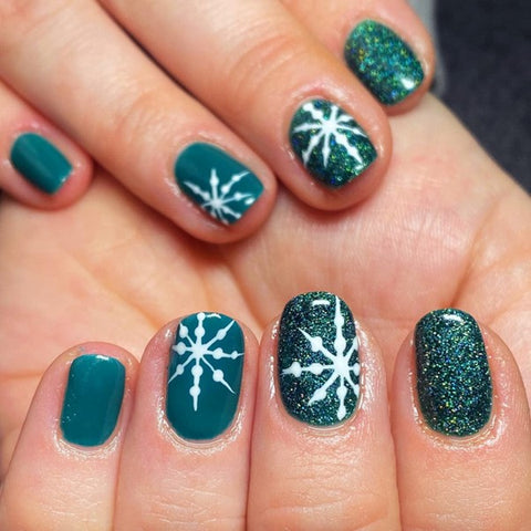 Short teal glitter Christmas nails with white snowflake art