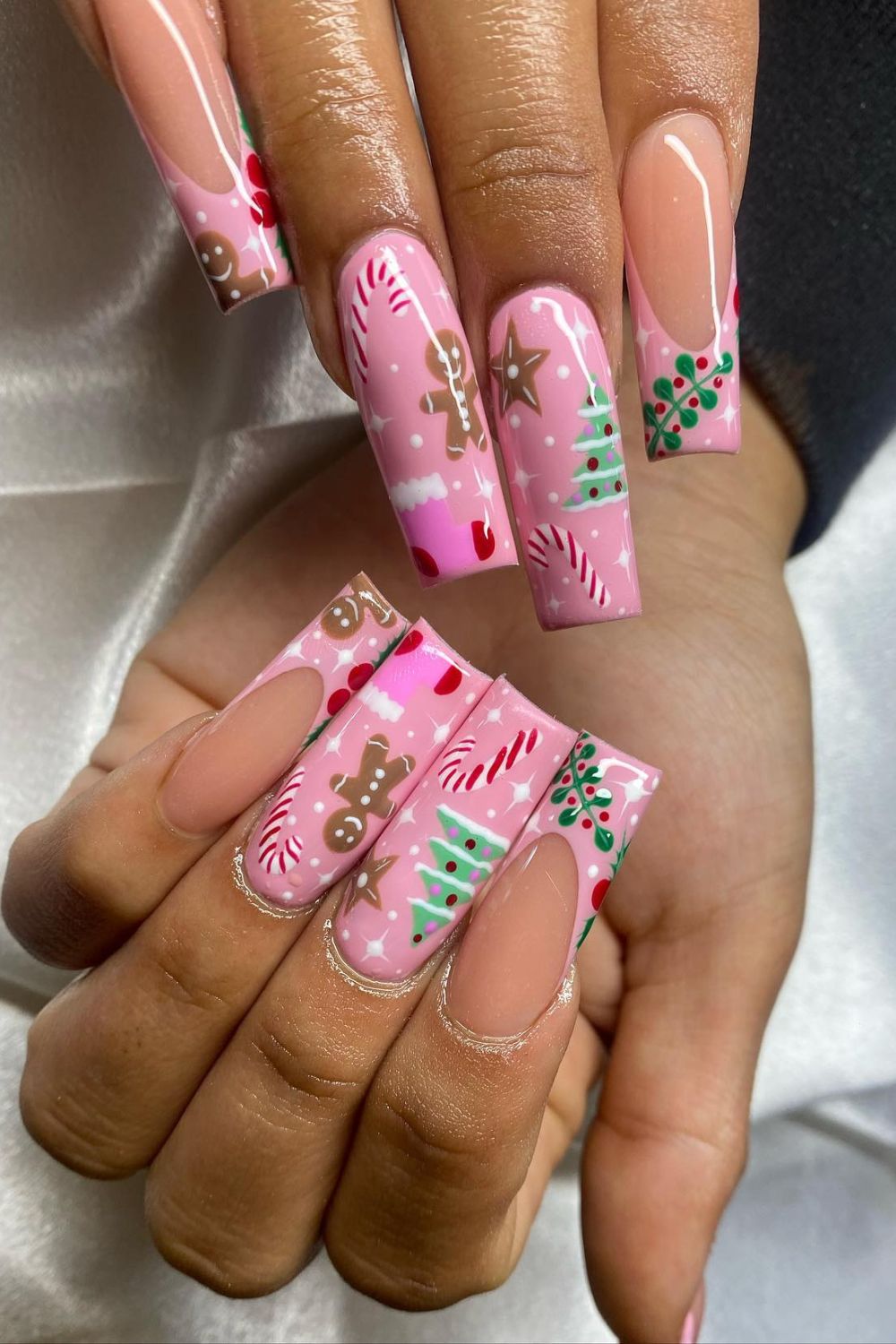 Pink coffin nails with gingerbread men, candy canes, trees and holly art