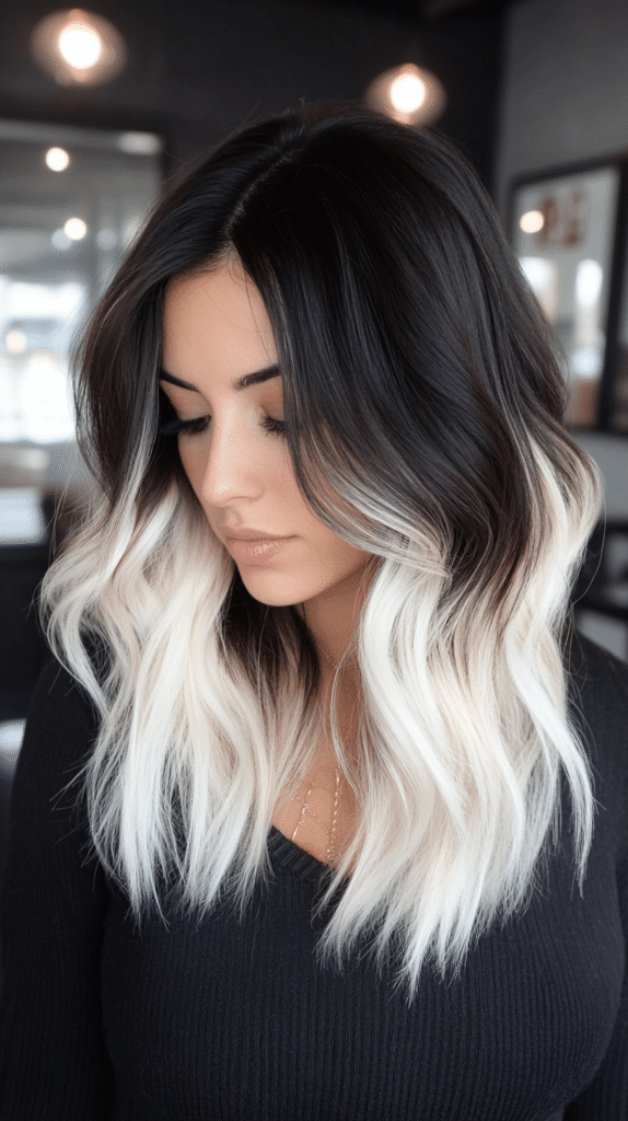 Long dark brown hair with a bold blonde money piece framing the face