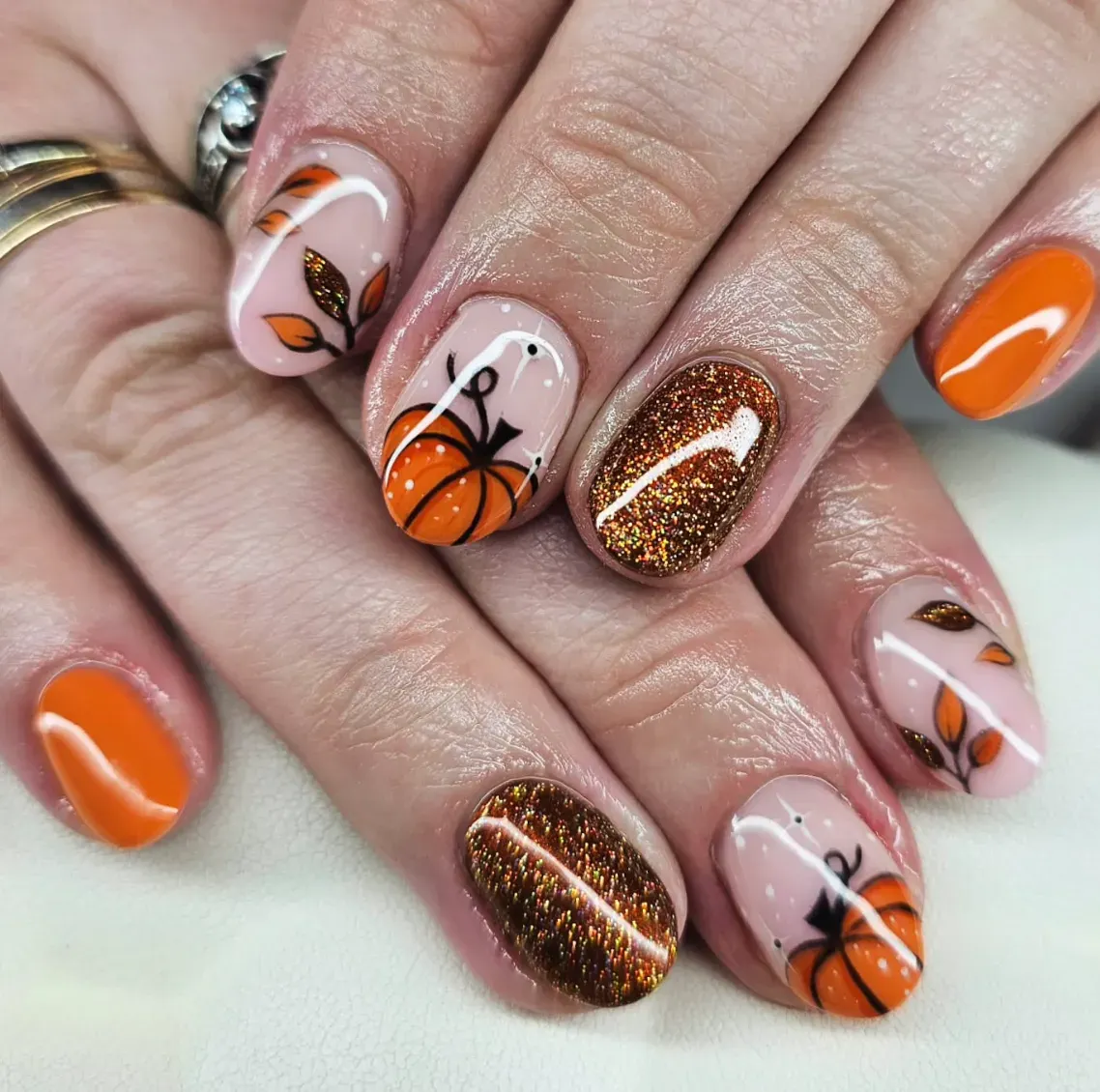 Orange nails with pumpkin nail art designs