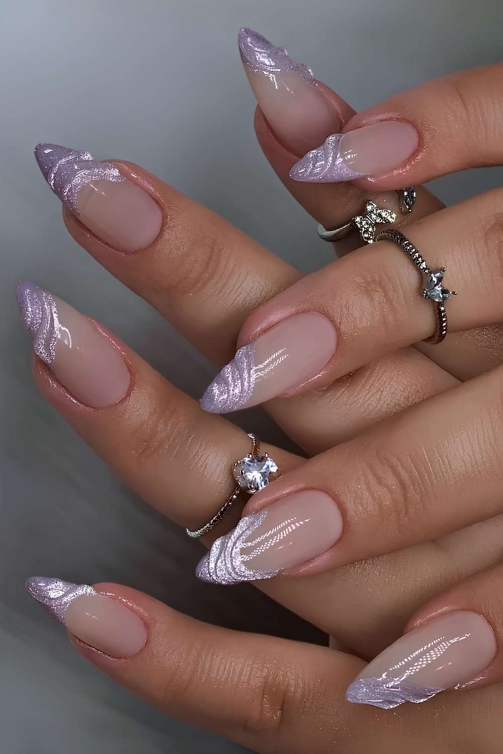 Almond nails with purple velvet cat-eye French tips and raised gel swirls