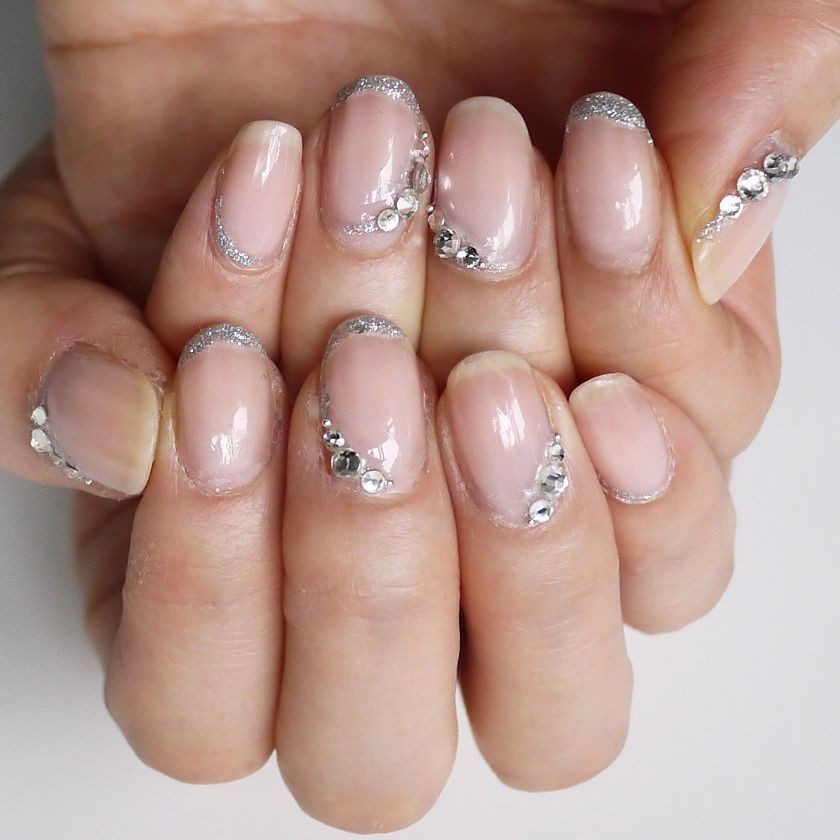 Nude nails with a silver half-moon detail at the cuticle