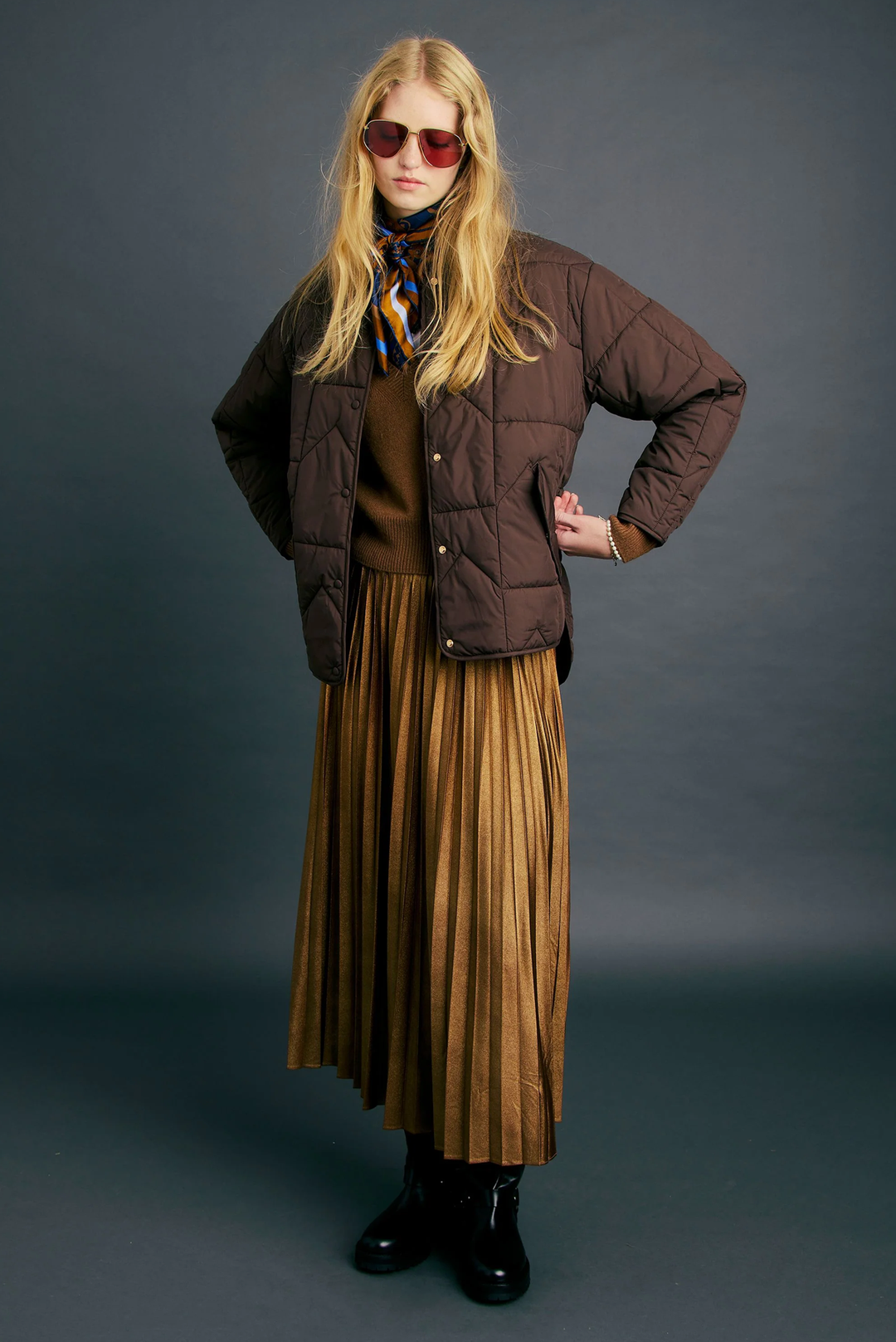 Quilted chocolate jacket styled with a pleated midi skirt for winter