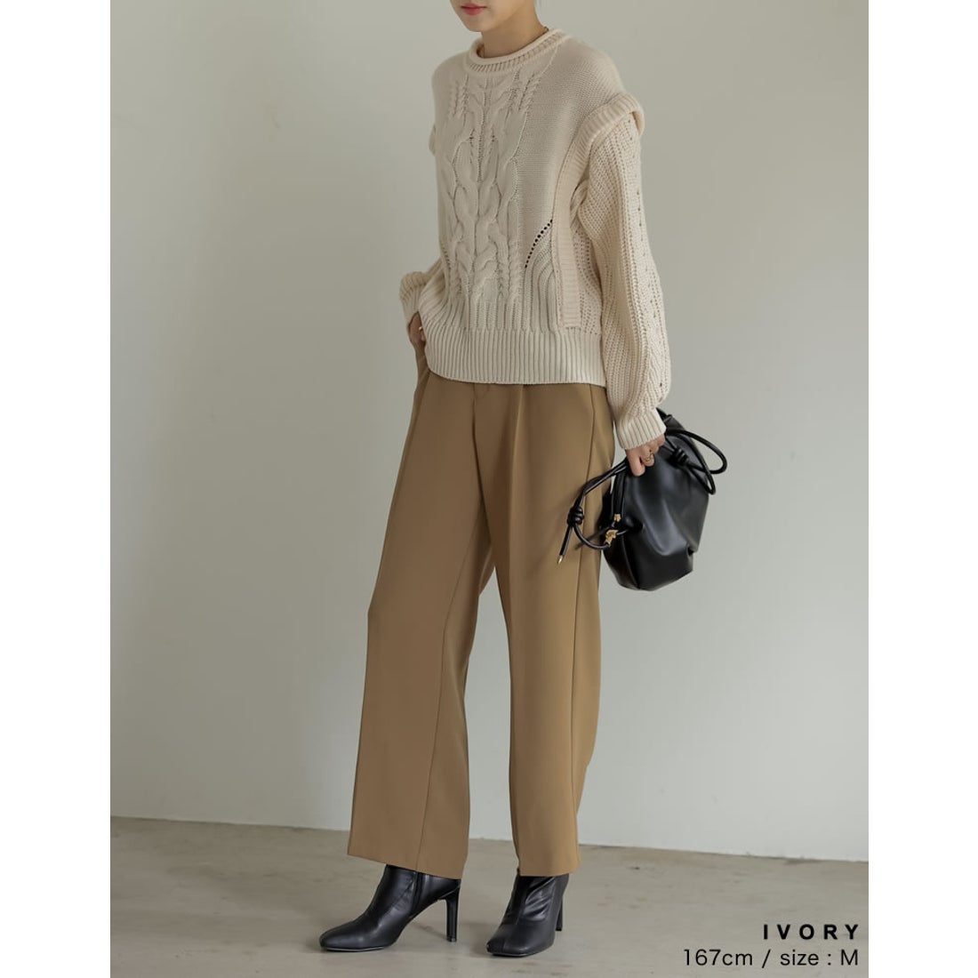 Ivory cable knit sweater with camel wide-leg trousers