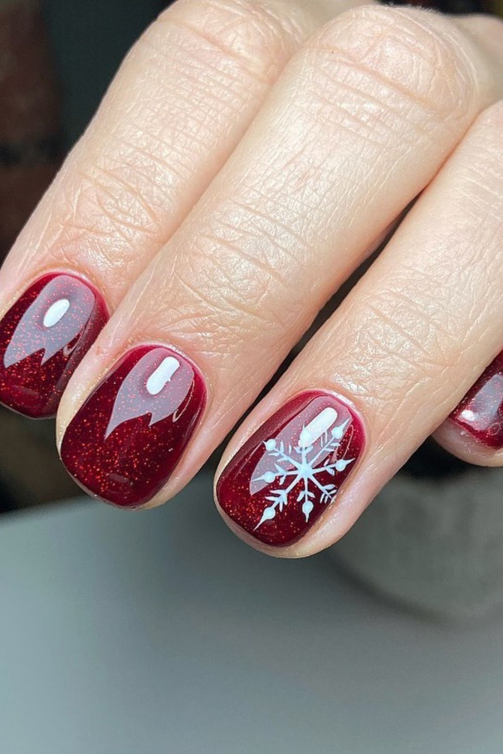Ruby red glitter nails with snowflake accent
