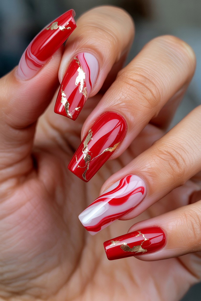 Long square nails in red marble with white swirls and gold foil veins
