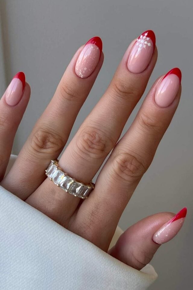 Red winter French manicure with white snowflake nail art accents