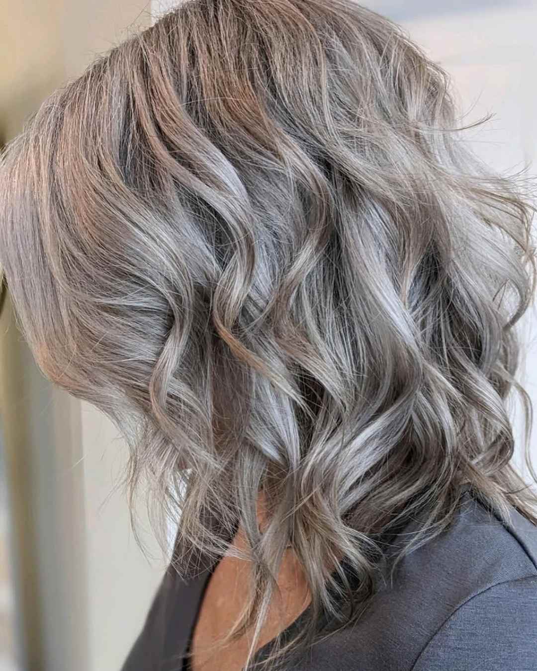 Ash blonde hair with silver ribbon highlights in soft waves