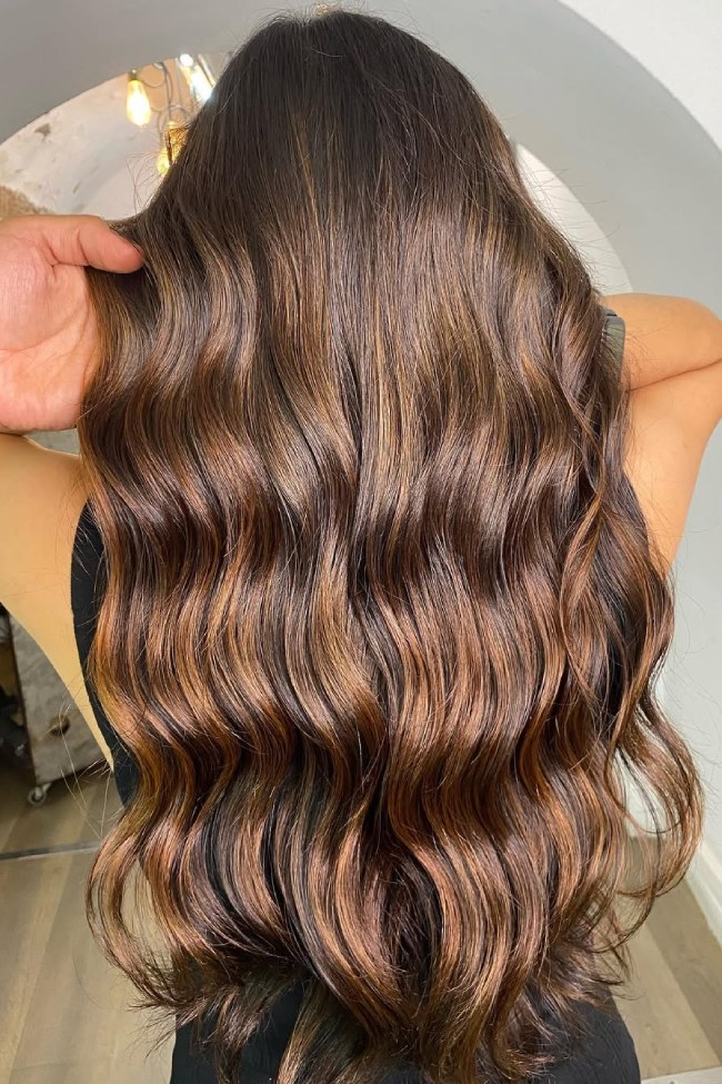Dark brunette hair with rich toffee mocha balayage and glossy dimension
