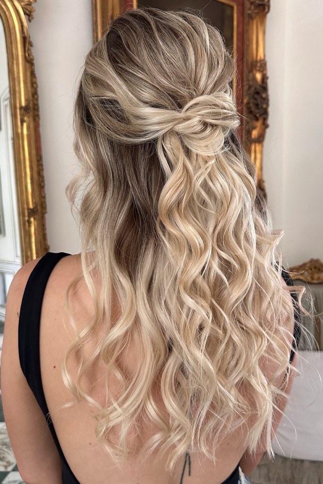 Half-up bow hairstyle with loose wavy hair