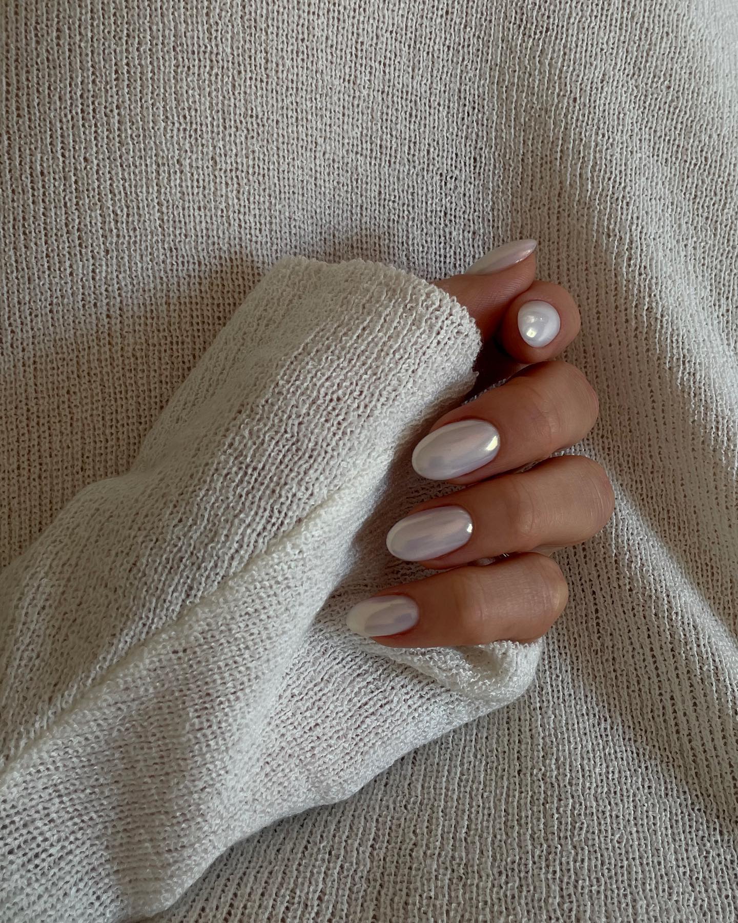 Milky white oval nails with a pearl chrome glaze