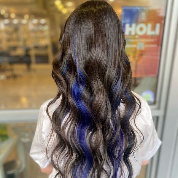 Midnight brown hair with sapphire blue peekaboo highlights underneath