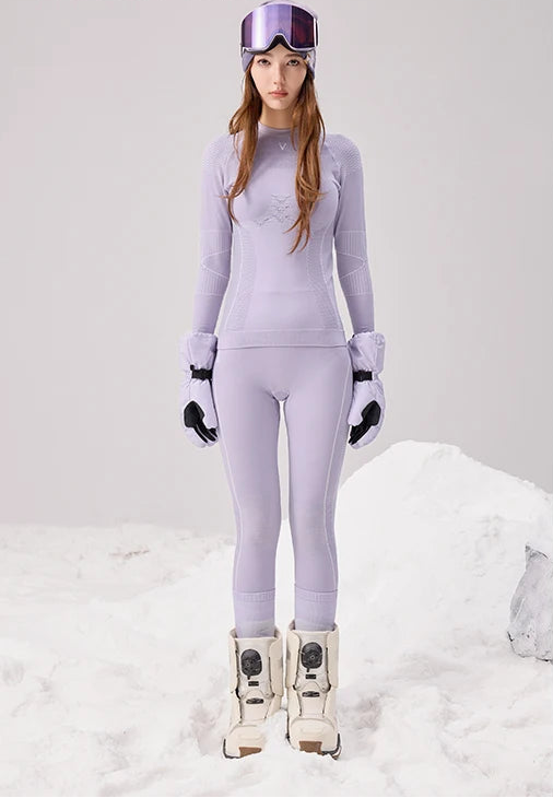 Woman wearing a lavender thermal base layer top and leggings set