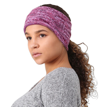 Woman wearing a purple knit headband with her curly hair in a low ponytail