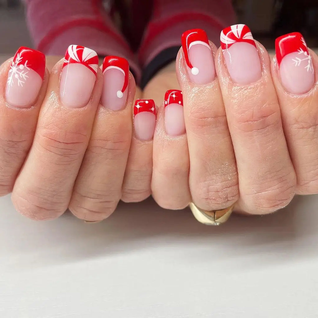 Santa hat nail design with red and white Santa hat tips