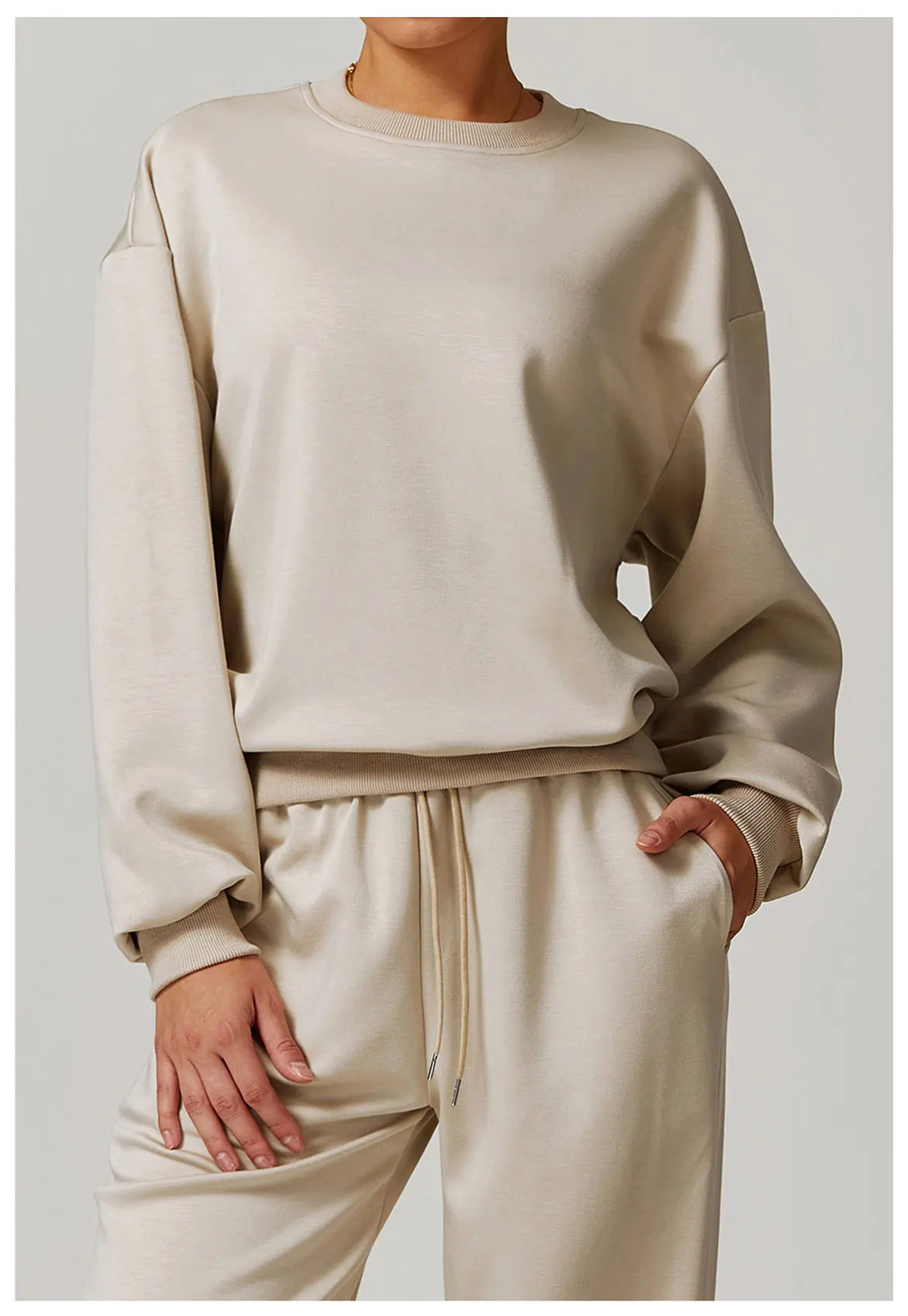 Close-up of an oatmeal oversized crewneck sweatshirt with matching drawstring sweatpants