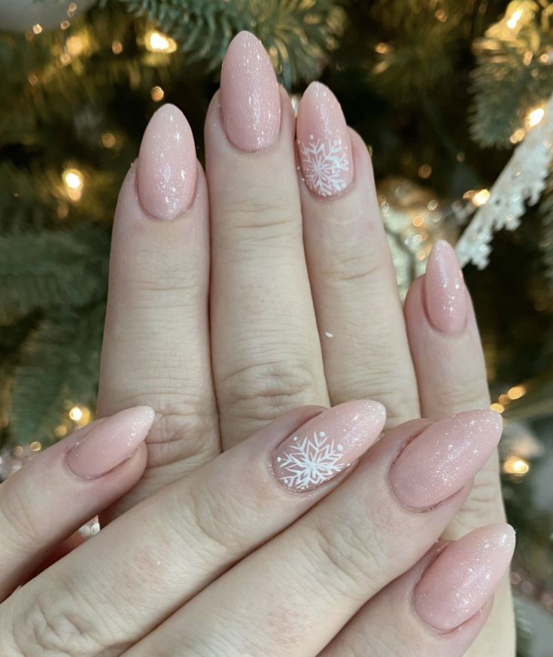 Pink oval nails with white snowflake nail art