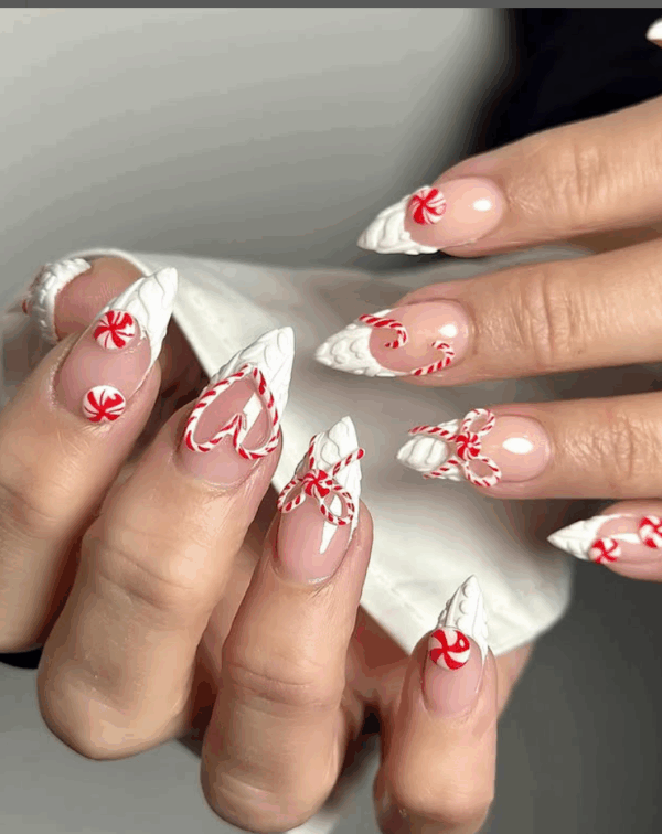 Nude stiletto nails with 3D white icing swirls and peppermint candy
