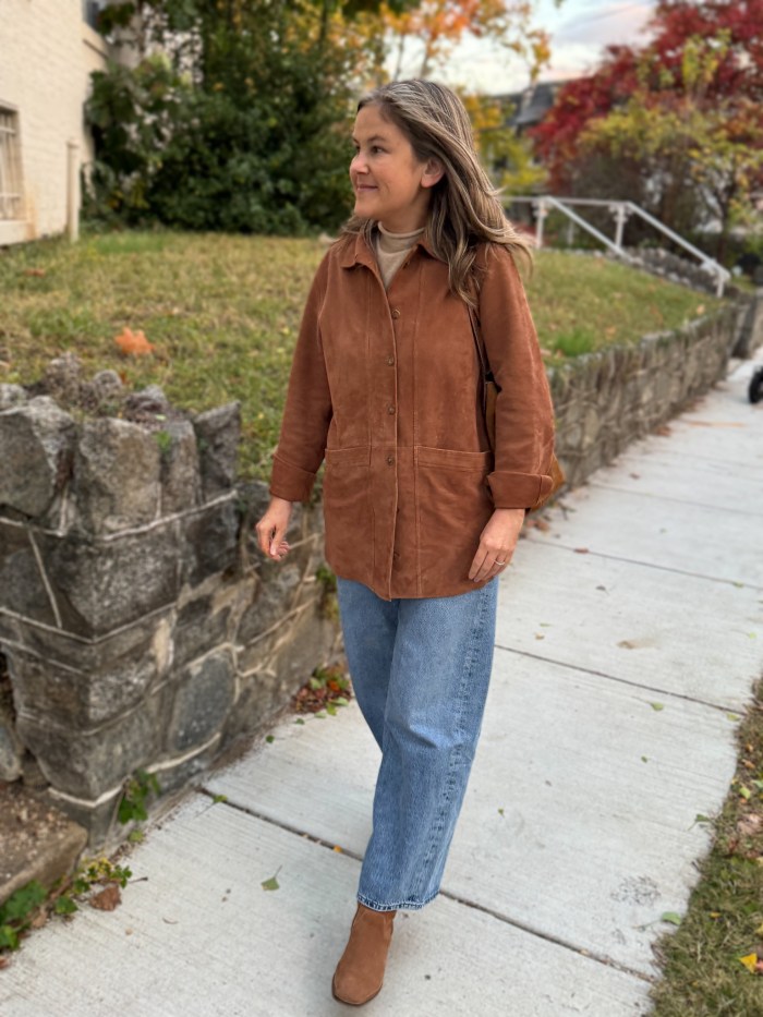 Buttoned suede shirt jacket worn over barrel-leg jeans