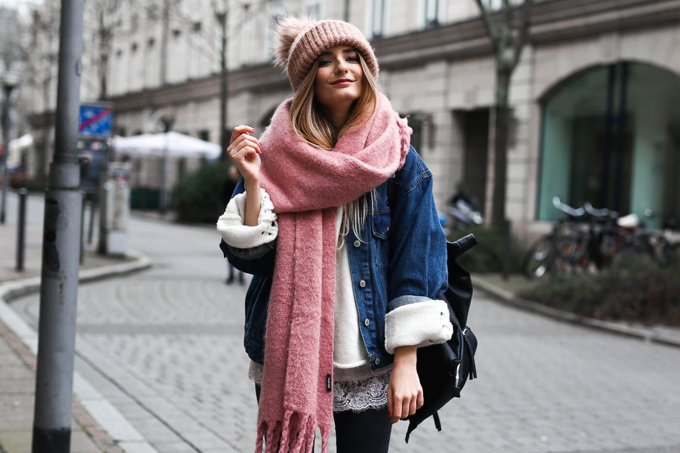 Denim jacket layered for winter with a beanie