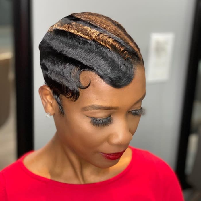 Sculpted finger waves with warm copper tones on short hair
