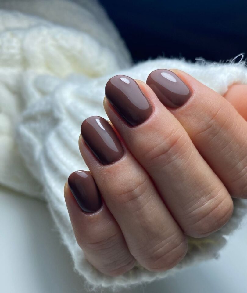 Short oval nails in a rich chocolate brown polish