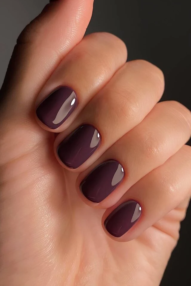 Dark Plum: an aubergine cream on medium almond nails