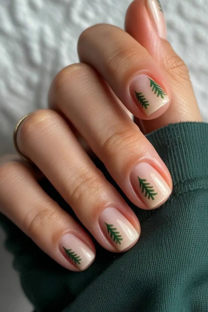Nude nails with one deep forest green accent nail
