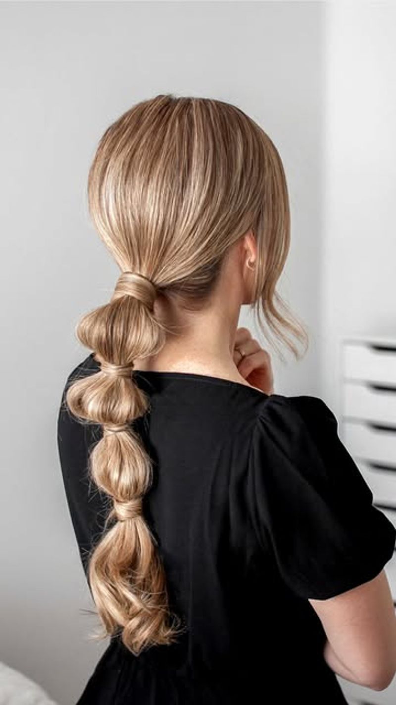 Back view of a blonde bubble braid ponytail