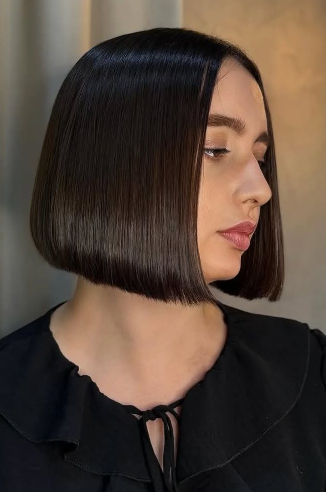 Sleek chin-length blunt espresso brown bob worn straight