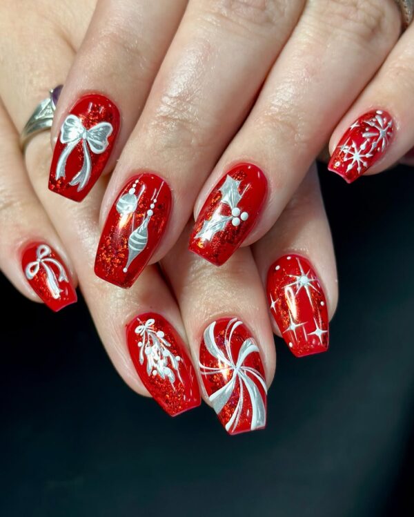 Red glitter nails with white Christmas bow and ornament nail art