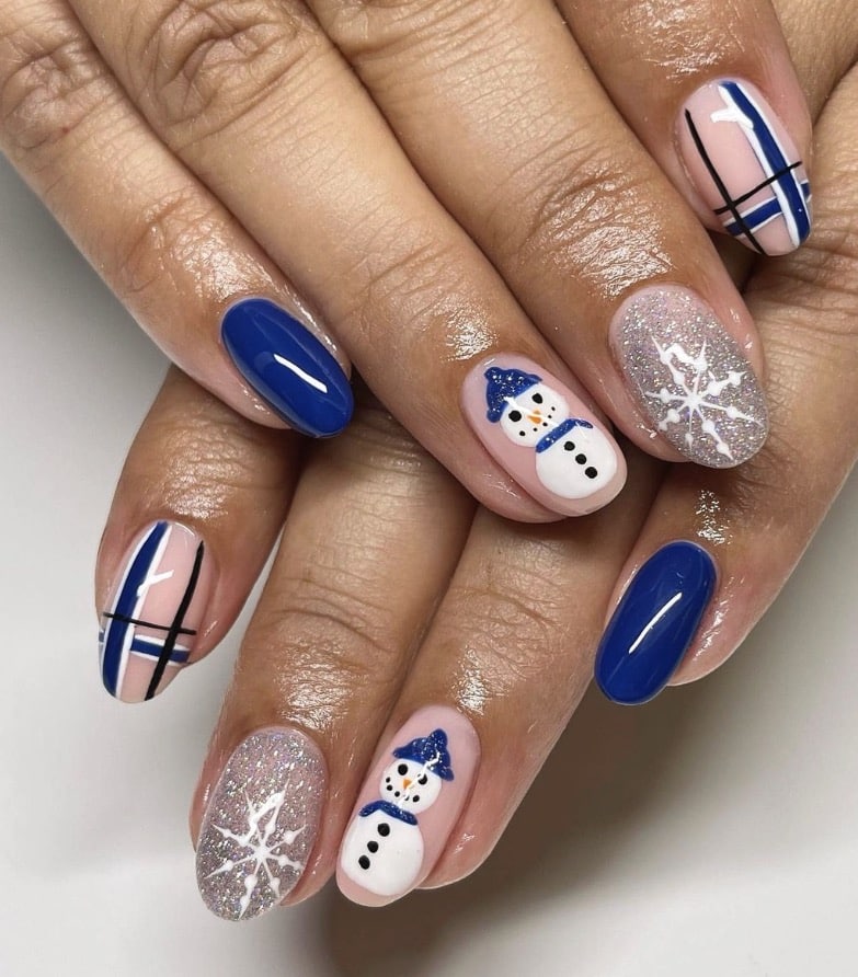 Blue snowman nail art with snowman accent nails