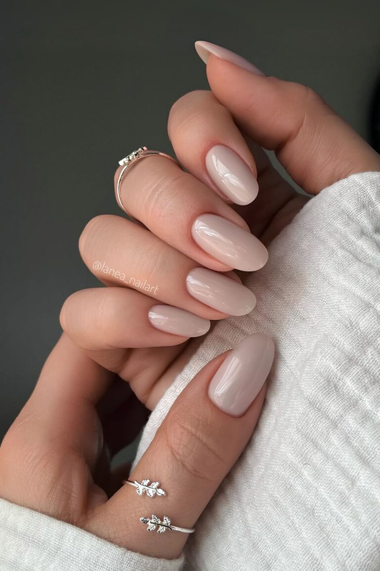 Glossy greige polish on oval-shaped nails