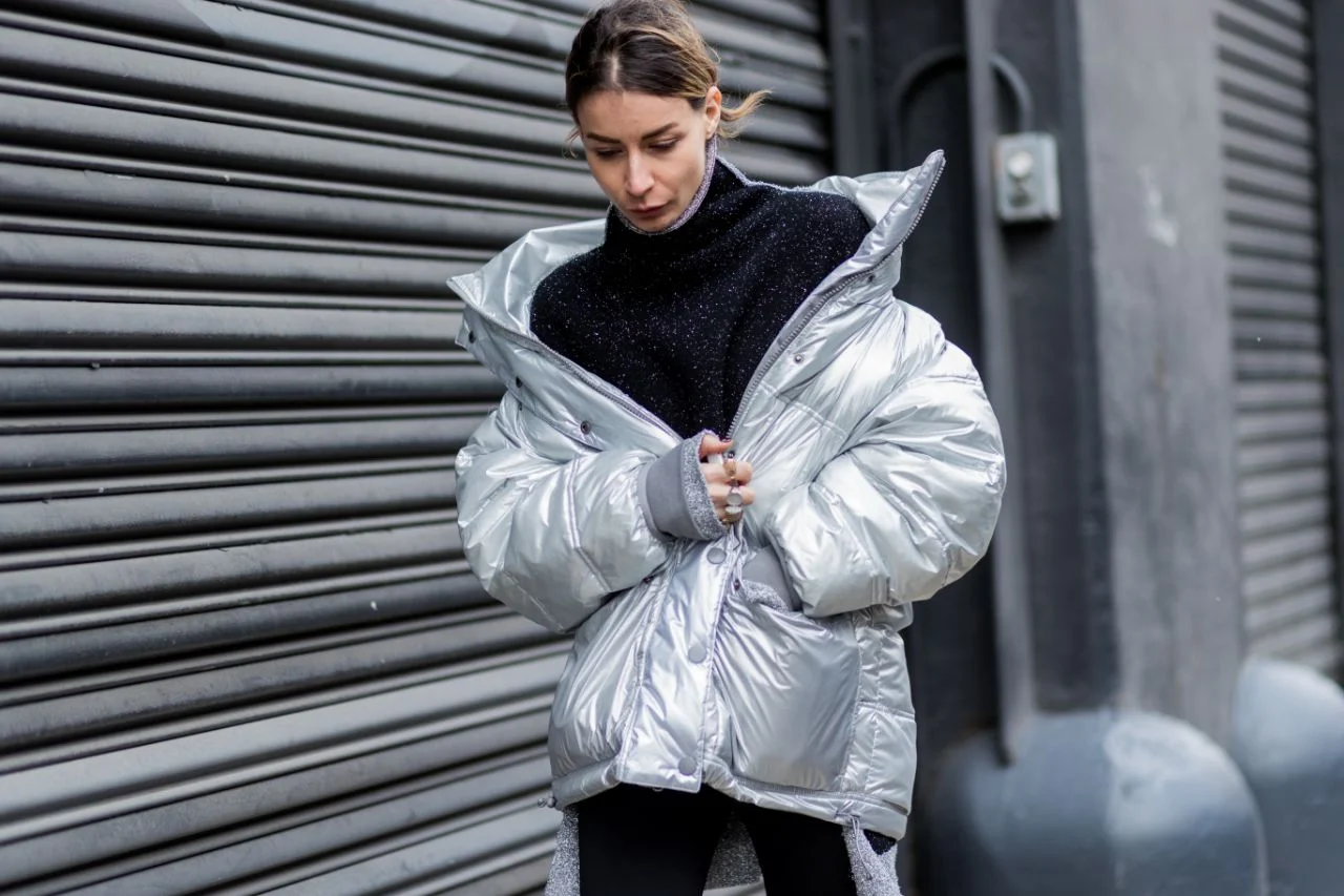 Woman wearing a mixed-media puffer jacket with a turtleneck on the street