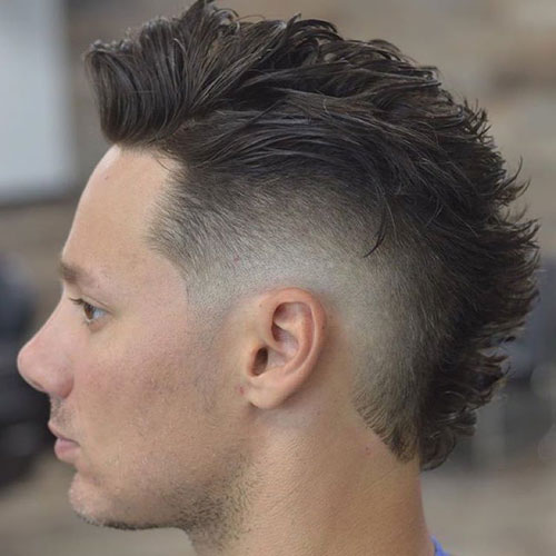 Man with a modern faux hawk and taper fade