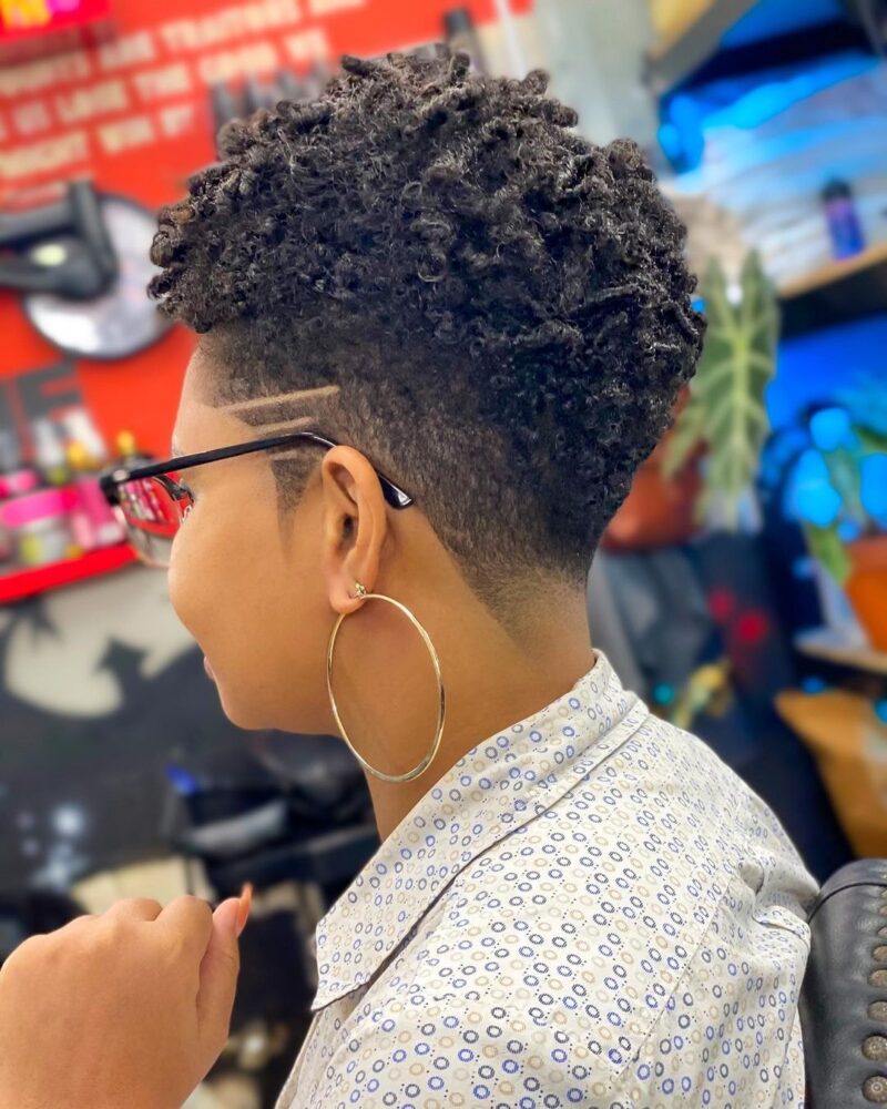Tapered curly haircut with short sides and full top