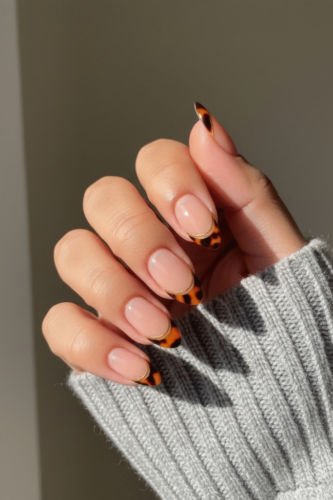 Nude nails with tortoiseshell accent nails