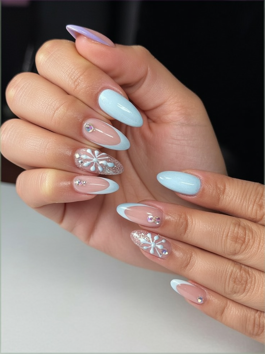 Light blue French tip nails with snowflake accents