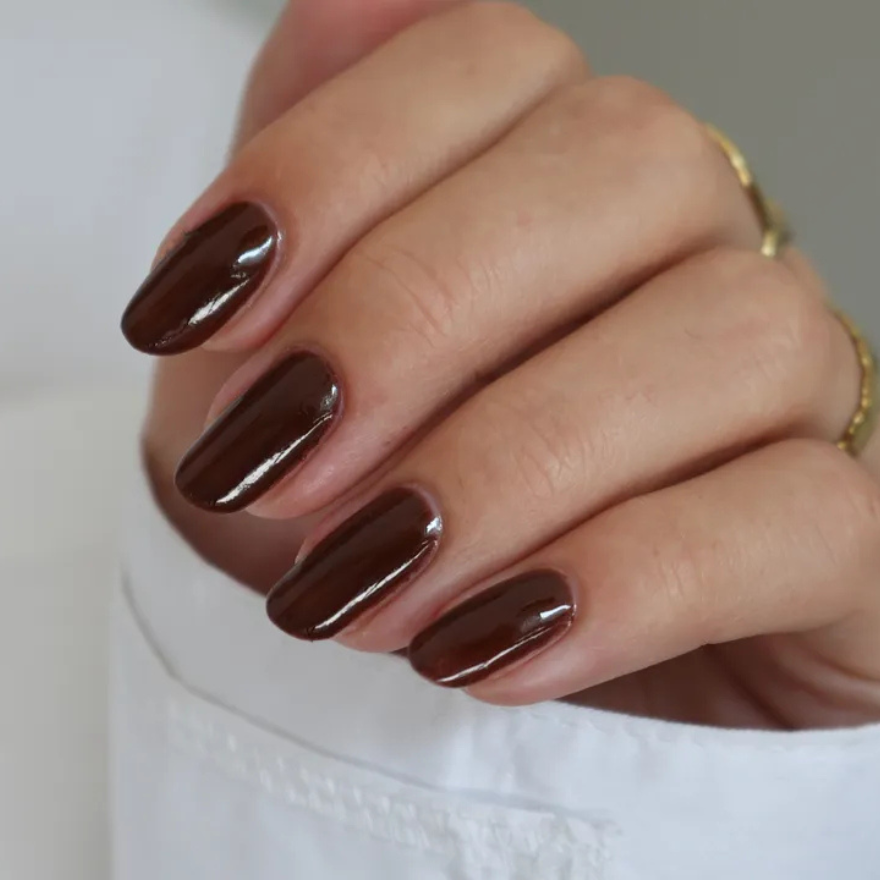 Medium almond nails in warm glossy mocha brown