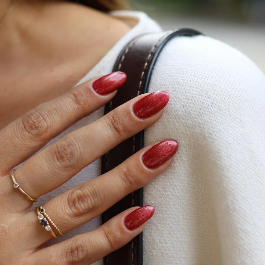 Medium almond nails in fiery red magnetic cat-eye polish