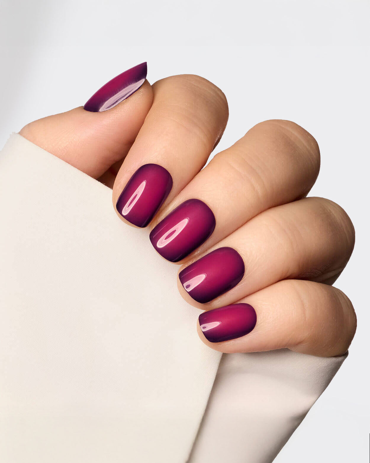 Short square nails in deep plum with a velvety matte finish