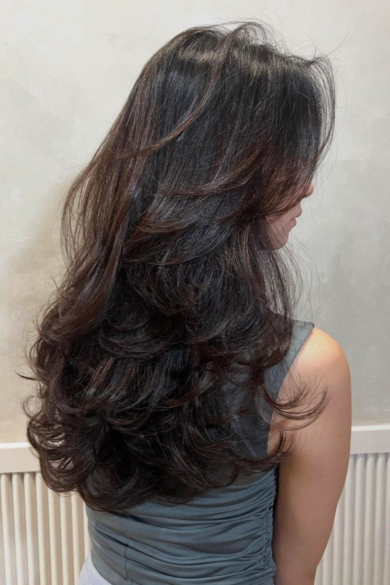 Back view of long dark wavy hair with soft layers
