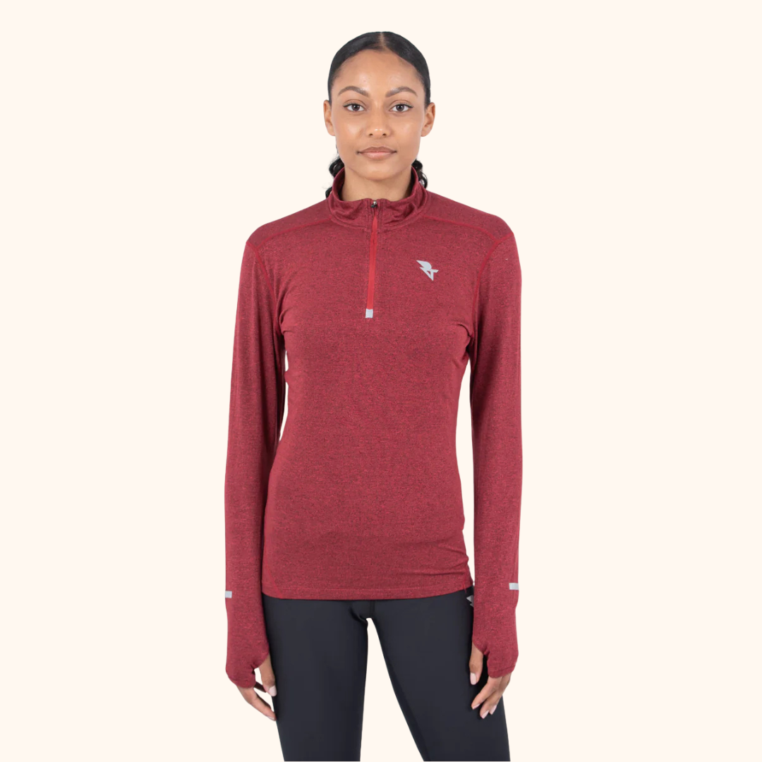 Woman wearing a red quarter-zip pullover with black leggings for a winter run