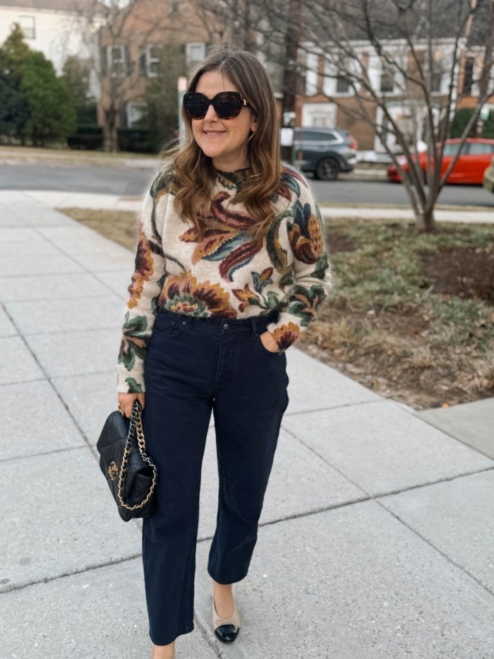 Colorful bright knit sweater with medium-wash barrel-leg jeans
