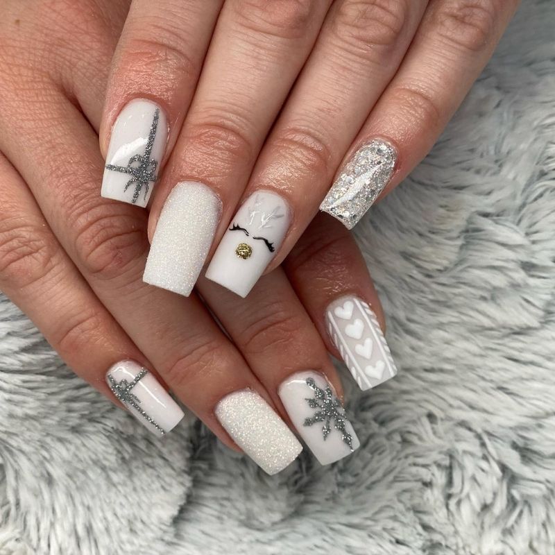 White coffin nails with reindeer face, silver glitter bows, snowflakes and hearts