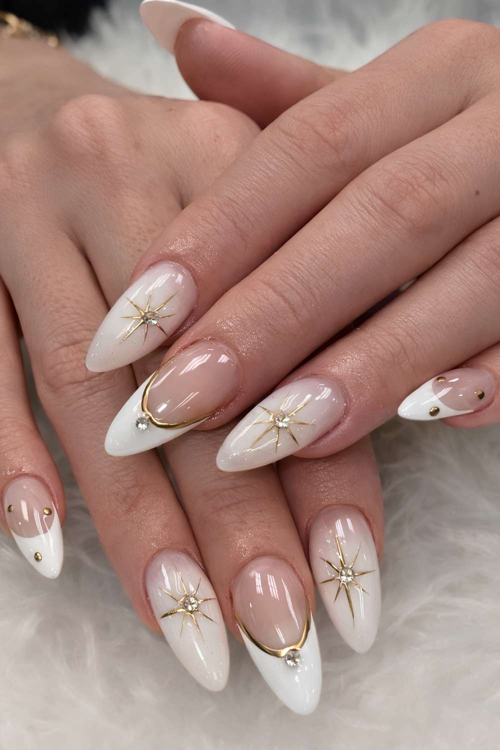 Milky white nails decorated with tiny gold stars