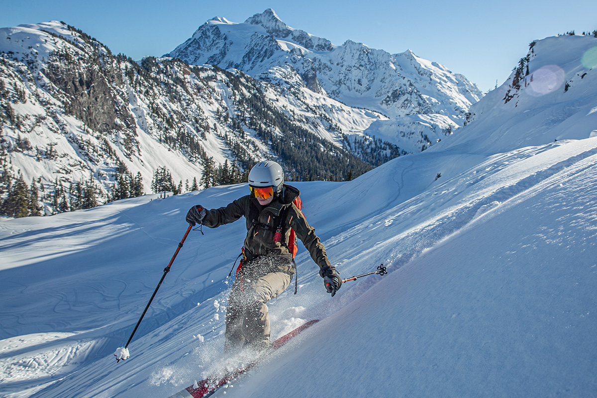 Woman wearing a technical ski jacket on a winter mountain outing