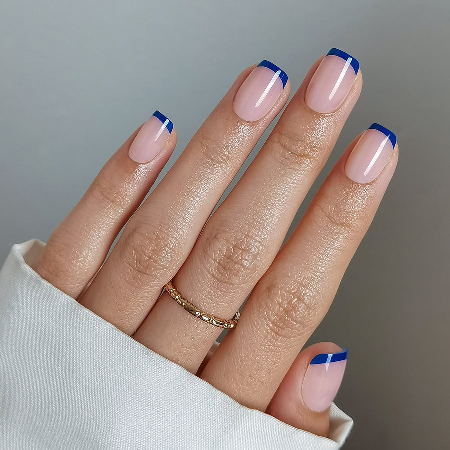 Short squoval nude nails with thin navy micro French tips